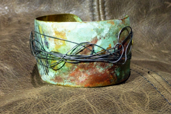 Embossed brass cuff with patina and steel
