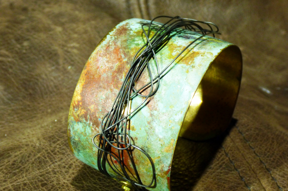 Embossed brass cuff with patina and steel