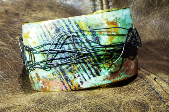 Embossed brass cuff with patina and steel