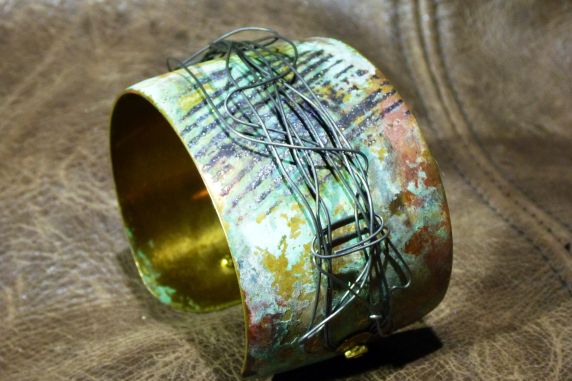 Embossed brass cuff with patina and steel