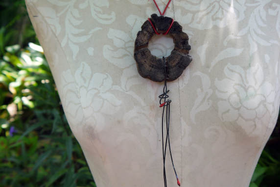 Concrete choya disc with dangling enamel charm