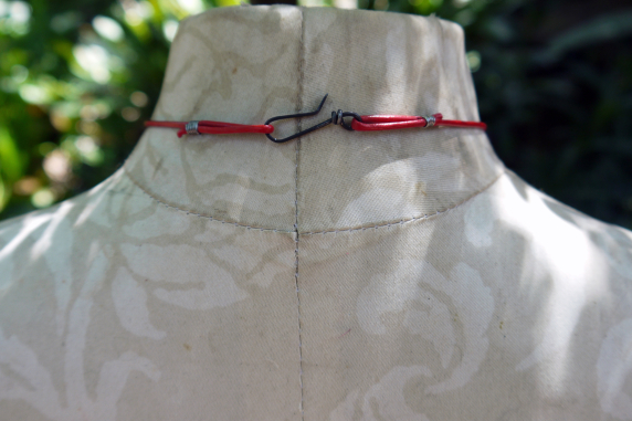 Concrete choya disc with dangling enamel charm