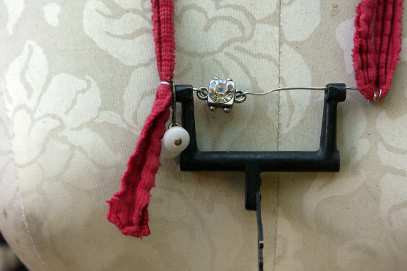 Recycled sewing machine part with hanging charm necklace