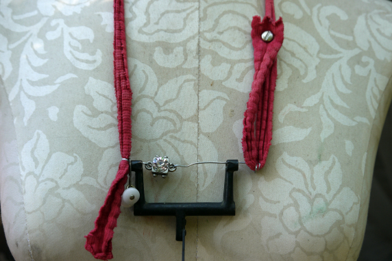 Recycled sewing machine part with hanging charm necklace