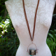 strung from suede Concrete vertebrae necklace with found objects