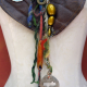 concrete charm, vintage accents and yarn fringe Gathered brown leather fringe bib necklace with blue capiz shell