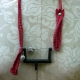 Recycled sewing machine part with hanging charm necklace