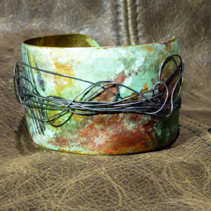 Embossed brass cuff with patina and steel