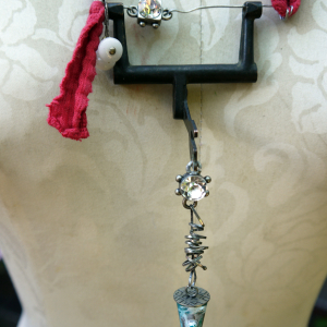 Recycled sewing machine part with hanging charm necklace