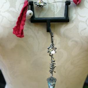 Recycled sewing machine part with hanging charm necklace